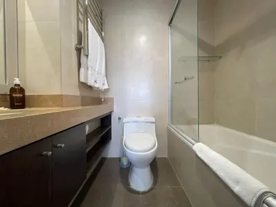 a bathroom with a toilet and a glass shower at BOEM Apartments by Vibrant in Lima