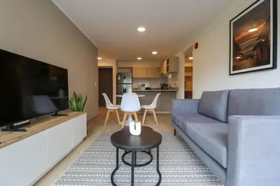 a living room with a couch and a television at Larco by Wynwood House in Lima