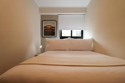 a bedroom with a large bed with a window at Larco by Wynwood House in Lima