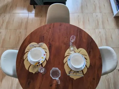 a wooden table with plates and glasses on it at Casa hogareña Pequeña in Ica