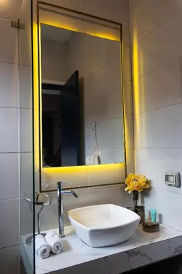 a bathroom sink with a large mirror above it at Olivar House Hotel in Lima