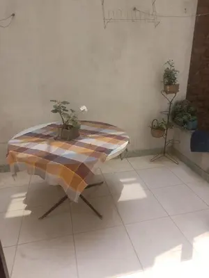 a table with a plaid table cloth and plants on it at Agua dulce in Lima