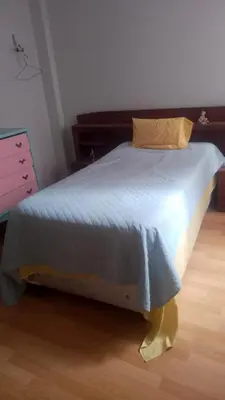 a large bed in a bedroom with a wooden floor at Agua dulce in Lima