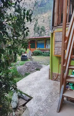 a house with a stone walkway next to a building at Wonderful Full House in Ollantaytambo
