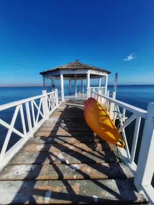 a yellow surfboard sitting on the end of a pier at Paracas Exclusivo Departamento familiar in Pisco