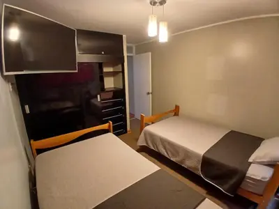 a small bedroom with a bed and a cabinet at Apartamento Ideal en Zona Céntrica in Lima