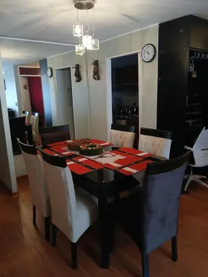 a dining room table with chairs and a clock on the wall at Apartamento Ideal en Zona Céntrica in Lima