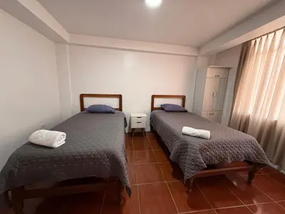 a bedroom with two beds and a window at Hostal La Reserva - Pisco in Pisco