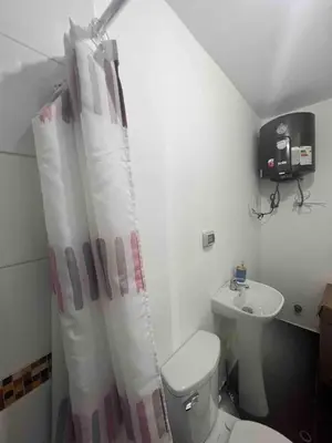 a small bathroom with a toilet and a sink at COSTANERA Uno in Lima