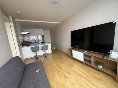 a living room with a large flat screen tv at COSTANERA Uno in Lima