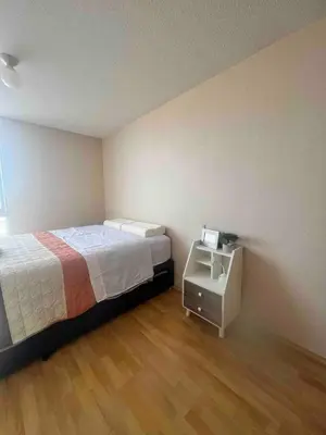a bedroom with a bed and a white night stand at COSTANERA Uno in Lima