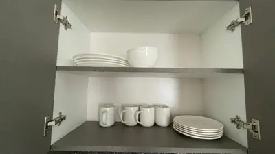 a pantry with plates and bowls on a shelf at Casa Departamento en el Valle de Urubamba in Urubamba