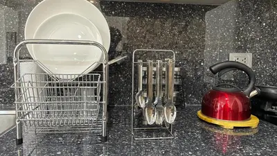 a kitchen counter with a tea kettle and utensils at Casa Departamento en el Valle de Urubamba in Urubamba