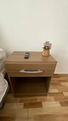 a wooden table with a remote control and a plant on it at Departamento en Urubamba in Urubamba