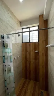 a bathroom with a shower with a glass door at Departamento en Urubamba in Urubamba