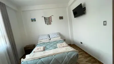 a small bedroom with a bed in a room at Departamento en Urubamba in Urubamba
