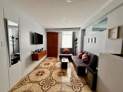 a living room with a couch and a tv at Cozy & Centric Apartment in great location! in Cusco