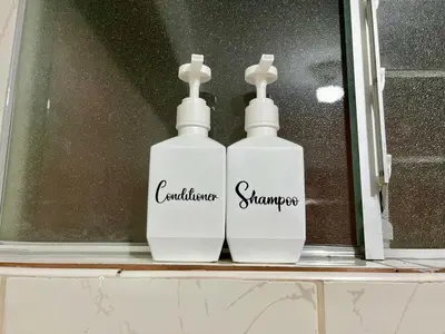 two white bottles sitting on a window sill at Cozy & Centric Apartment in great location! in Cusco