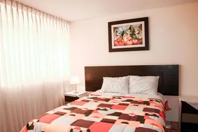 a bedroom with a bed and a picture of fruit at Hotel Bartol in Huancayo