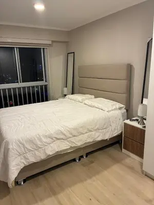a bedroom with a large bed and a window at Modern apartment overlooking Parque de las Aguas in Lima