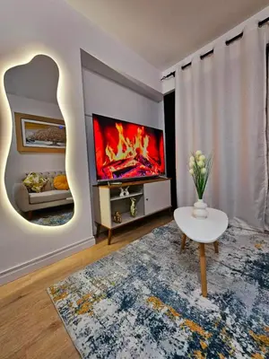 a living room with a fireplace and a tv at Apartamento Moderno in Lima