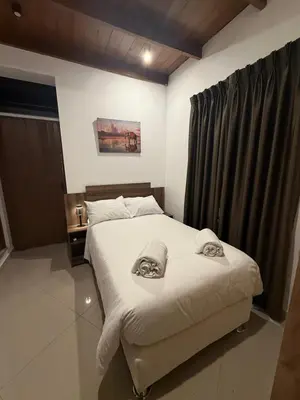 a bedroom with a bed with towels on it at Serendipia City Comfort Suite 901 in Lima