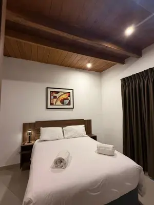 a bedroom with a large bed with white sheets at Serendipia City Comfort Suite 901 in Lima