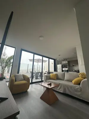 a living room with a couch and a table at Luxury Duplex on the 15th Floor with Terrace in Lima