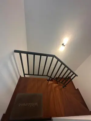 a wooden staircase with a light on the ceiling at Luxury Duplex on the 15th Floor with Terrace in Lima