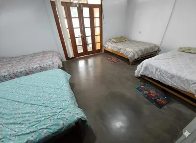 a room with three beds in a room at Casa de campo El paraiso cerca a Lima in Nuevo Imperial