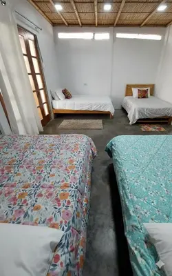 a room with two beds in a room with windows at Casa de campo El paraiso cerca a Lima in Nuevo Imperial