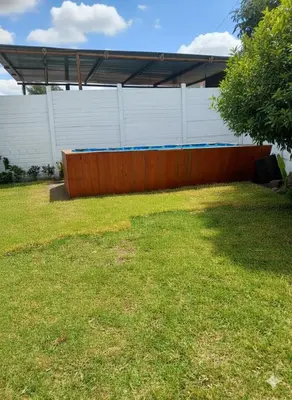 a large yard with a fence and a building at Casa de campo El paraiso cerca a Lima in Nuevo Imperial