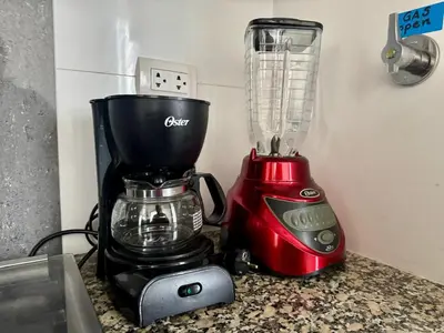 a red blender sitting on top of a counter at Departamento completo vista al mar,piscina,gimnasio,WIFI,Tvs in Lima