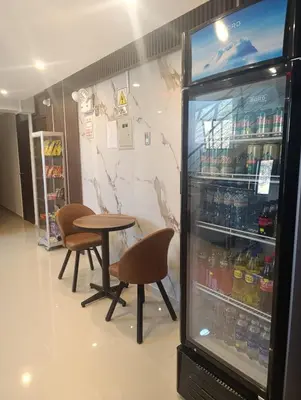 a refrigerator with a table and chairs in a store at Kapricho Wanka in Huancayo
