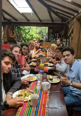 a group of people sitting at a table eating food at EColodge Ccatan in Urubamba