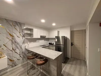 a kitchen with a counter and a refrigerator at Apartment in San Miguel De Estreno in Lima