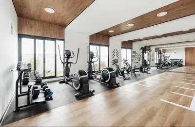 a gym with several treadmills and cardio machines at Apartment in San Miguel De Estreno in Lima