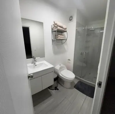 a bathroom with a toilet and a sink and a shower at Apartment in San Miguel De Estreno in Lima