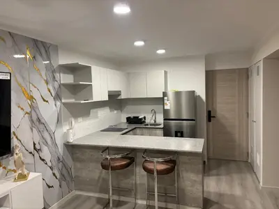 a kitchen with a counter and a refrigerator at Apartment in San Miguel De Estreno in Lima