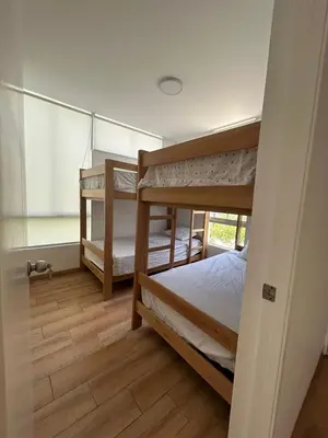 a bedroom with two bunk beds and a window at Beach House in Asia, Santorini Condominio in Asia