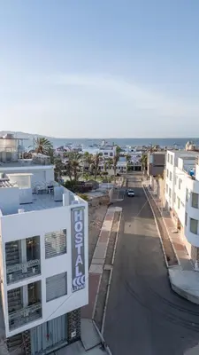 an empty street in a city with buildings at Hostal 3 Lunas in Paracas