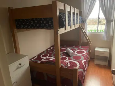 a bedroom with a bunk bed with a phone on it at New Apartment near the airport with parking in Lima