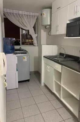 a kitchen with white cabinets and a sink at New Apartment near the airport with parking in Lima