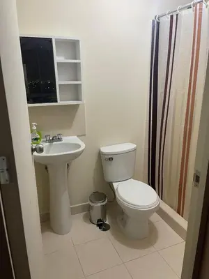 a bathroom with a toilet and a sink at New Apartment near the airport with parking in Lima