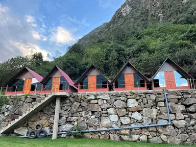 a row of houses on a stone wall at AndeStay Hostel Chaullay in Colcapampa
