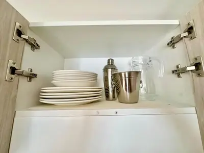 a cupboard with plates and dishes on top of it at Apartment in the center of Miraflores Larco in Lima