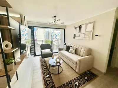 a living room with a couch and a table at Apartment in the center of Miraflores Larco in Lima