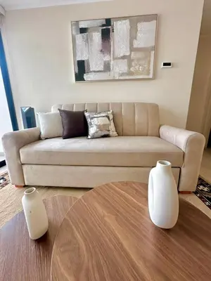 a living room with a couch and two white vases at Apartment in the center of Miraflores Larco in Lima