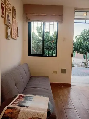 a living room with a couch and a window at Casa Sunampe Chincha in Sunampe