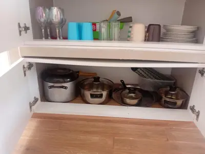 a kitchen pantry with pots and pans and dishes at Casa Sunampe Chincha in Sunampe